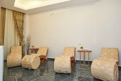 a waiting room with three chairs and two tables at Sultan Suleyman Palace Hotel & Spa in Istanbul