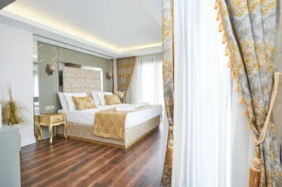a bedroom with a king sized bed and a window at Sultan Suleyman Palace Hotel & Spa in Istanbul