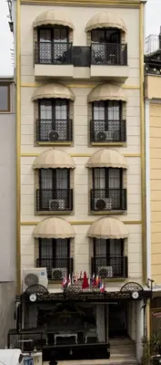 a building with balconies and flags on a balcony at Sultan Suleyman Palace Hotel & Spa in Istanbul