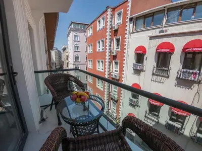a balcony with a table with a bowl of fruit on it at Crowned Hotel in Istanbul