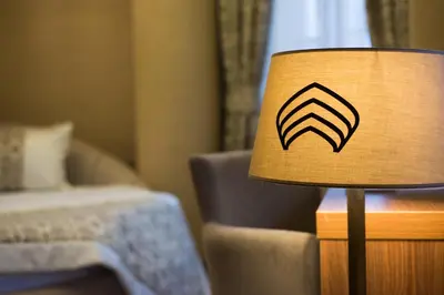 a lamp in a hotel room with a symbol on it at Cesmeli Konak Hotel Silivri in Silivri
