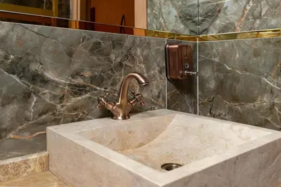 a sink in a bathroom with a faucet at The Ottoman in Istanbul