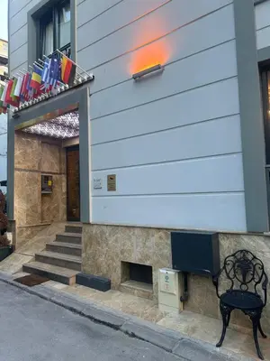 a bench sitting in front of a building with flags at The Ottoman in Istanbul