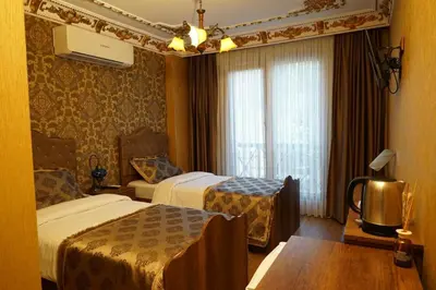 a hotel room with two beds and a window at The Ottoman in Istanbul