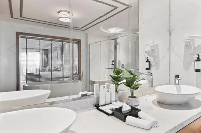 a white bathroom with a sink and a tub at Birun Ada Hotel in Istanbul