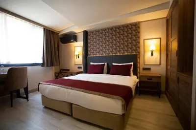 a hotel room with a large bed and a desk at Beşiktaş Serenity Hotel in Istanbul
