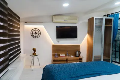 a bedroom with a bed and a tv on the wall at The Havana Residence in Istanbul