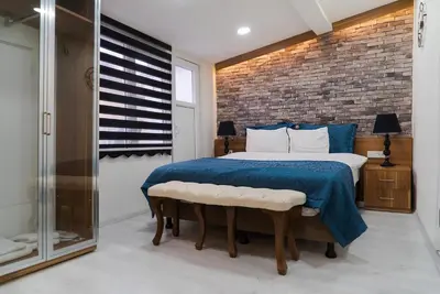 a bedroom with a bed and a brick wall at The Havana Residence in Istanbul