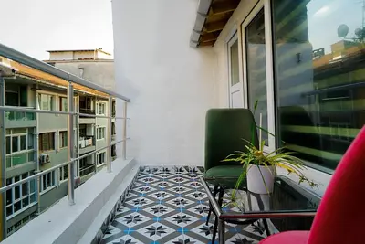 a balcony with a green chair and a floor at The Havana Residence in Istanbul