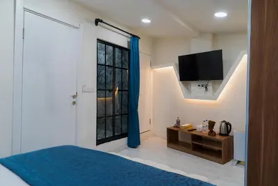 a bedroom with a bed and a tv and a window at The Havana Residence in Istanbul