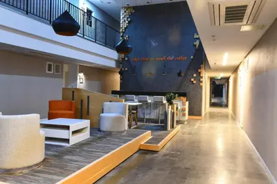 a lobby of a restaurant with tables and chairs at G Tower Furnished Apartment Rentals in Istanbul