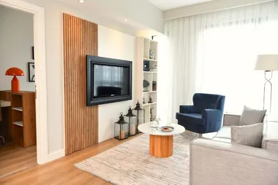 a living room with a couch and a tv at G Tower Furnished Apartment Rentals in Istanbul