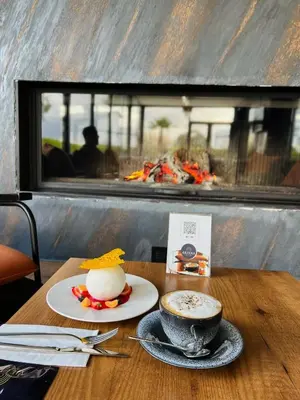 a table with a cup of coffee and a plate of food at Aileena Hotel & Villas in Kartepe