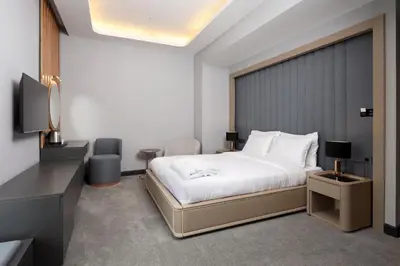 a hotel room with a bed and a television at Aileena Hotel & Villas in Kartepe