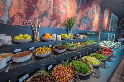 a buffet line with bowls of fruits and vegetables at Levor Hotel in Bursa