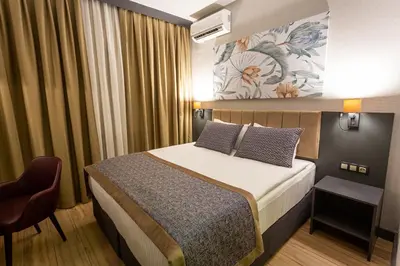 a hotel room with a bed and a chair at Levor Hotel in Bursa
