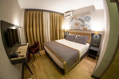 a hotel room with a bed and a television at Levor Hotel in Bursa