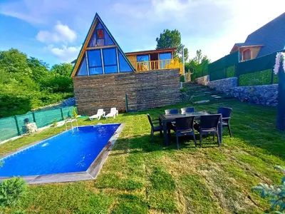 a house with a pool and a table and chairs at Dorabungalov in Sakarya