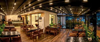 a restaurant with tables and chairs in a room at THE NOVA HOTEL in Yalova
