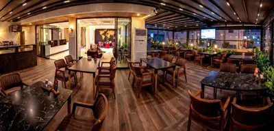 a restaurant with wooden floors and tables and chairs at THE NOVA HOTEL in Yalova