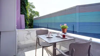 a small table and chairs on a balcony at SEVEN ROSES APART HOTEL in Istanbul