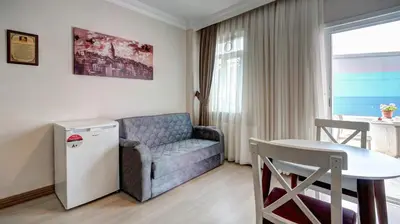 a small living room with a couch and a table at SEVEN ROSES APART HOTEL in Istanbul
