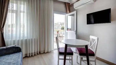 a small room with a table and a window at SEVEN ROSES APART HOTEL in Istanbul