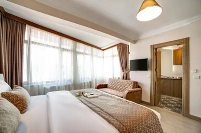 a hotel room with a bed and a chair at SEVEN ROSES APART HOTEL in Istanbul