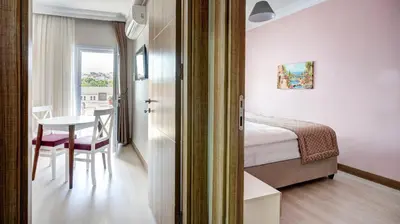 a room with a table and a bed and a table and chairs at SEVEN ROSES APART HOTEL in Istanbul