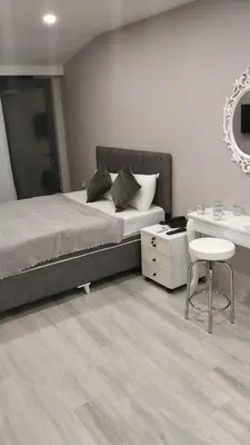 a bedroom with a bed and a desk and a chair at ATİK HOTEL in Istanbul