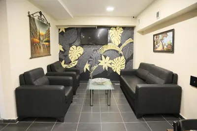 a waiting room with two couches and a flat screen tv at ATİK HOTEL in Istanbul