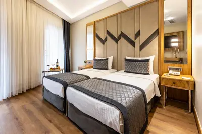 a hotel room with two beds and a window at Endican Sultanahmet Hotel in Istanbul