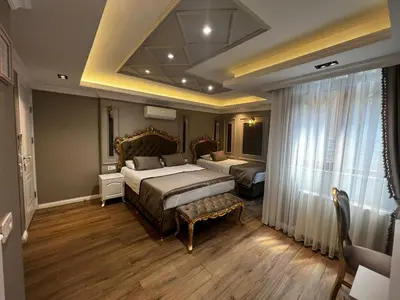a bedroom with two beds and a large window at Violette Mansion Oldcity in Istanbul