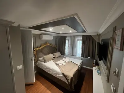 a bedroom with a bed and a television in it at Violette Mansion Oldcity in Istanbul