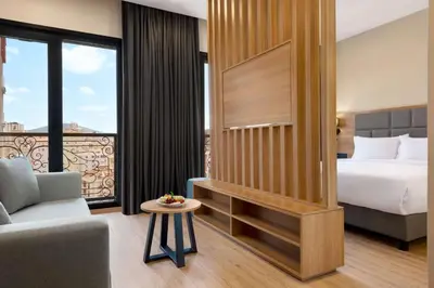 a hotel room with a bed and a couch at Tryp by Wyndham Istanbul Atasehir in Istanbul
