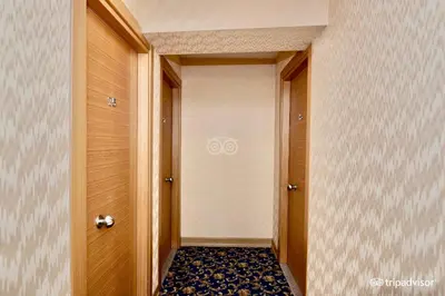 a hallway with two wooden doors and a tile floor at Timeks Hotel Sultanahmet in Istanbul