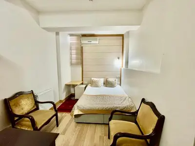 a small room with a bed and two chairs at Timeks Hotel Sultanahmet in Istanbul