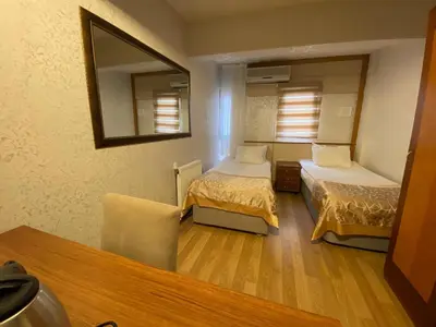 a small room with two beds and a mirror at Timeks Hotel Sultanahmet in Istanbul