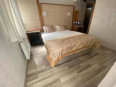 a bedroom with a bed and a wooden floor at Timeks Hotel Sultanahmet in Istanbul