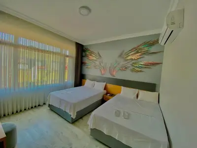 a bedroom with two beds and a painting on the wall at Victorious Hotel in Istanbul