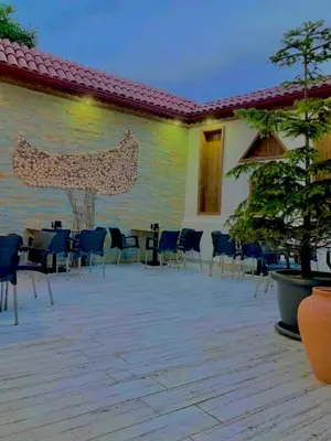 a patio with chairs and tables and a building at Victorious Hotel in Istanbul