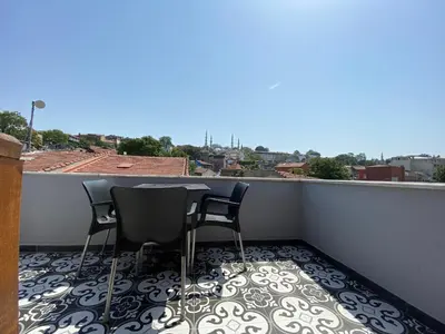a balcony with two chairs and a table on a roof at Victorious Hotel in Istanbul
