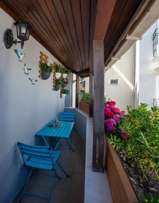 a patio with blue chairs and flowers on it at Duru Sultanahmet Apart & Suites in Istanbul