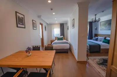 a room with two beds and a table in it at Duru Sultanahmet Apart & Suites in Istanbul