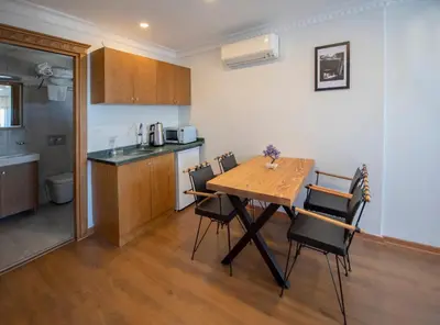 a kitchen and dining room with a wooden table and chairs at Duru Sultanahmet Apart & Suites in Istanbul