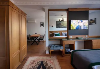 a bedroom with a bed and a tv on a mirror at Duru Sultanahmet Apart & Suites in Istanbul