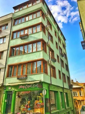 a tall building with a store in front of it at Pera Pansiyon in Bursa