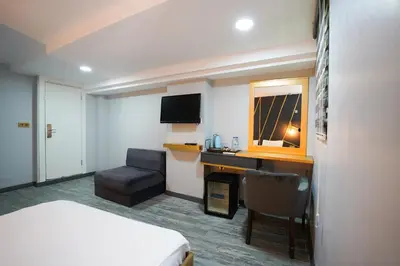 a hotel room with a bed and a desk and a chair at Time Hotel Mecidiyekoy in Istanbul