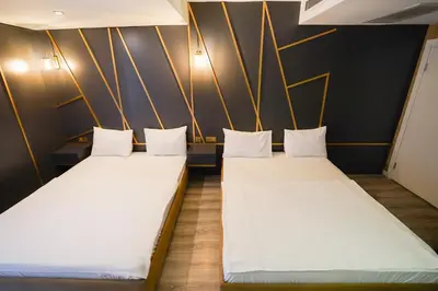 two beds in a room with black walls and white pillows at Time Hotel Mecidiyekoy in Istanbul