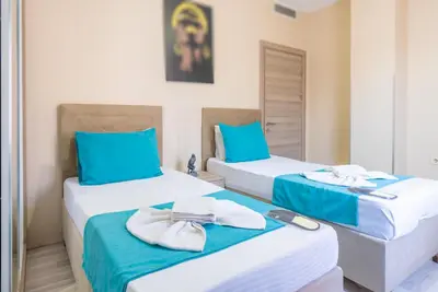 two beds in a room with blue and white at MELİSA SUİT RESİDENCE in Istanbul